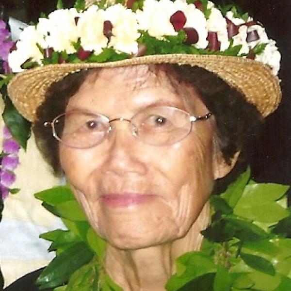 Portrait of woman with flower-laced hat.