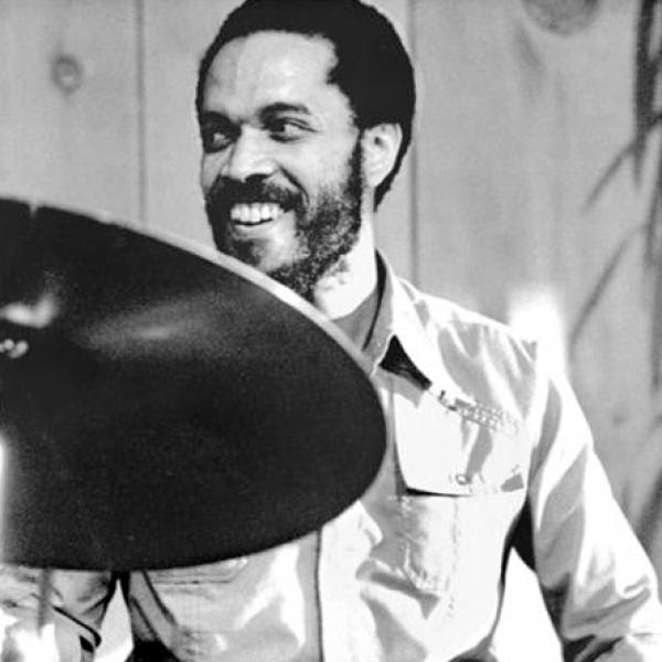 Man behind drum set. 