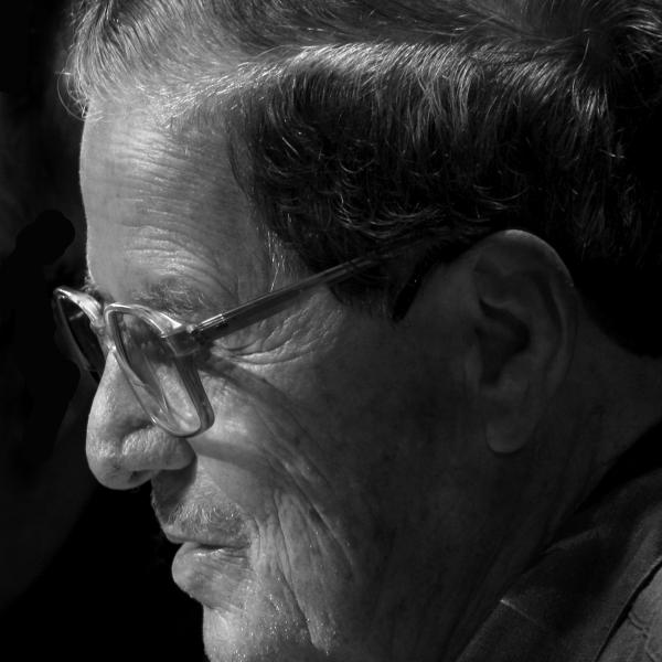 Hispanic man wearing glasses with short hair in profile.