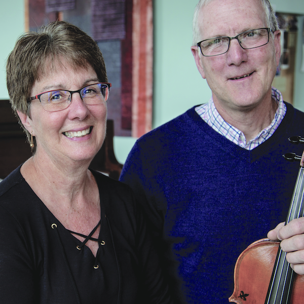 A man and a woman pose for the camera.