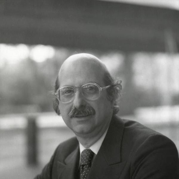 Portrait of bald man with glasses.