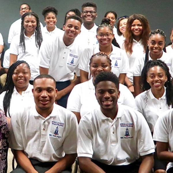 Close up of a group  of college age african american students posing for a group picture