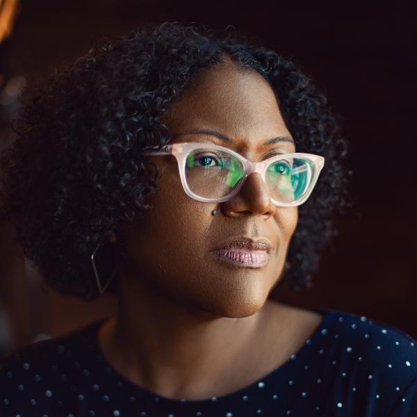Author photo of Honorée Fanonne Jeffers, who is wearing pink glasses and a polka dot top.