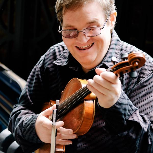 A man holding a fiddle