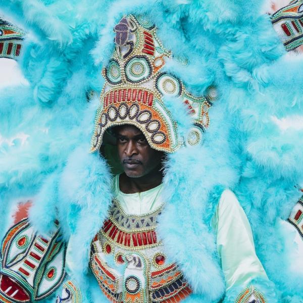 A man in a featherede costume.