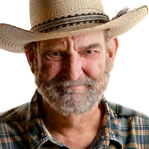 Portrait of man in straw hat.