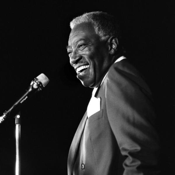 Man standing in front of mic stand. 