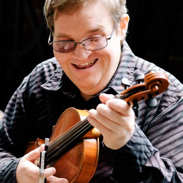 A man holding a fiddle.
