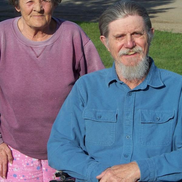 A man and a woman pose for the camera.