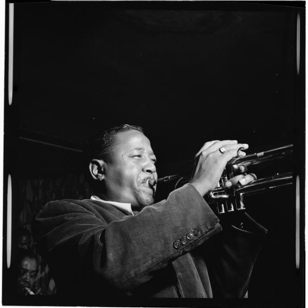 Man playing trumpet on stage. 