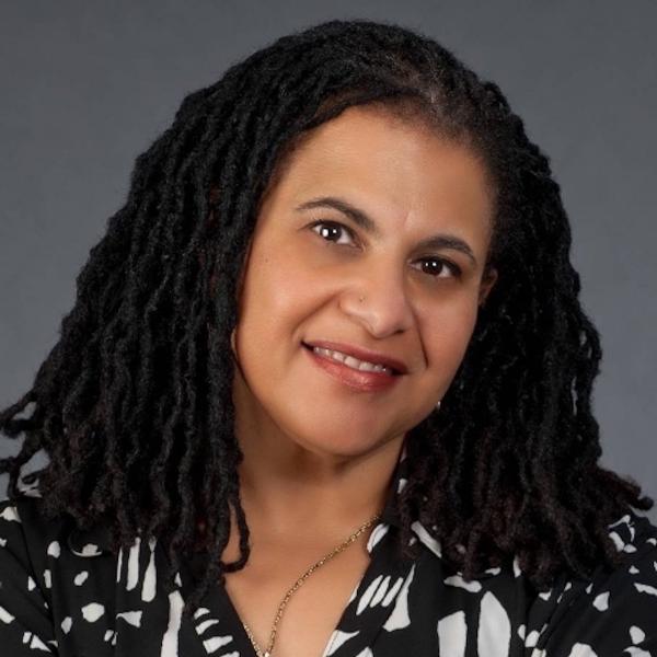Portrait of Black woman with long braided hair.