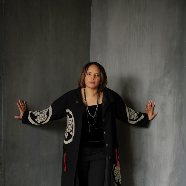 Woman in jacket standing in corner of room