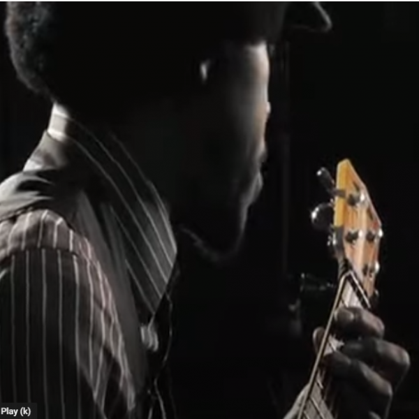 man playing ukelele.