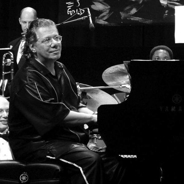 Man playing piano on stage.