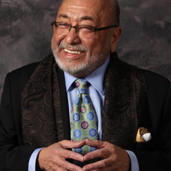 Man smiling with hands close together