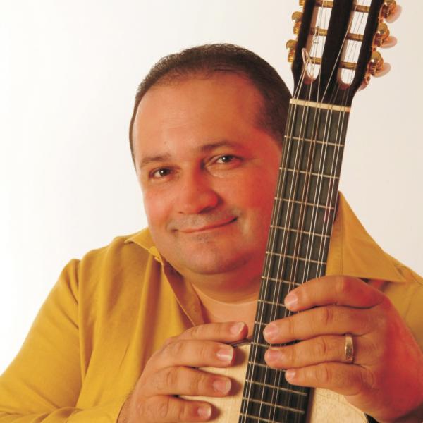 Man holding a cuatro.