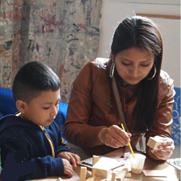 Woman and young man working on an art project at a table