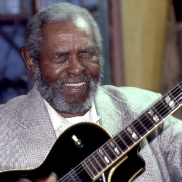 A man playing a guitar.