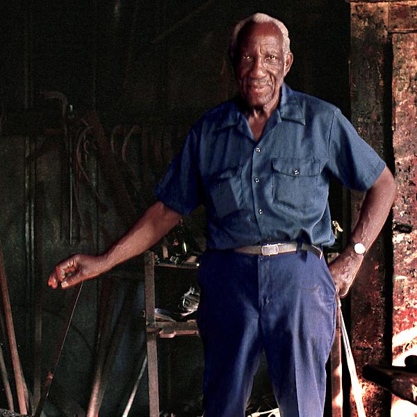 A man holing an iron rod.