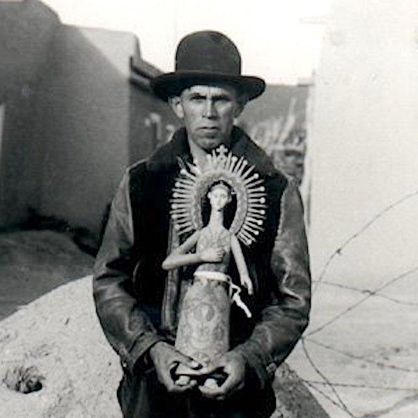 A man holding a ceramic sculpture.