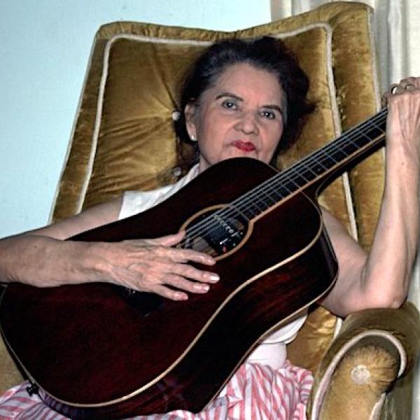 A woman playing a guitar.