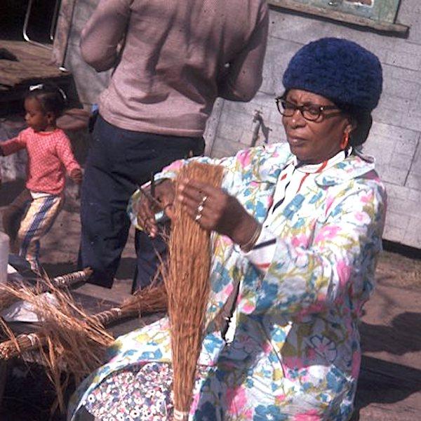 A woman making a straw broom.