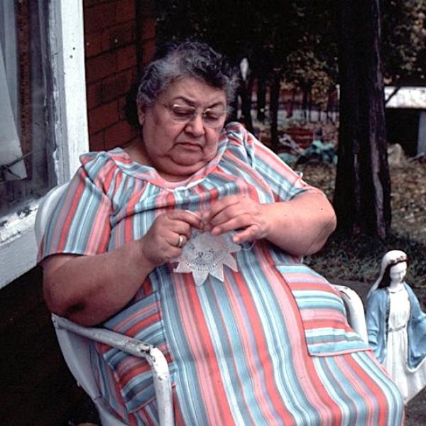 A woman woreks on a lace piece.