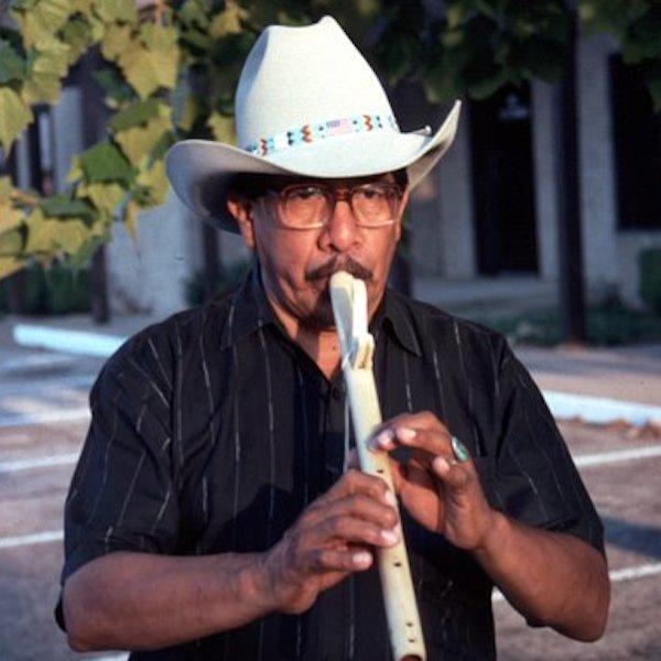 Man playing a flute.