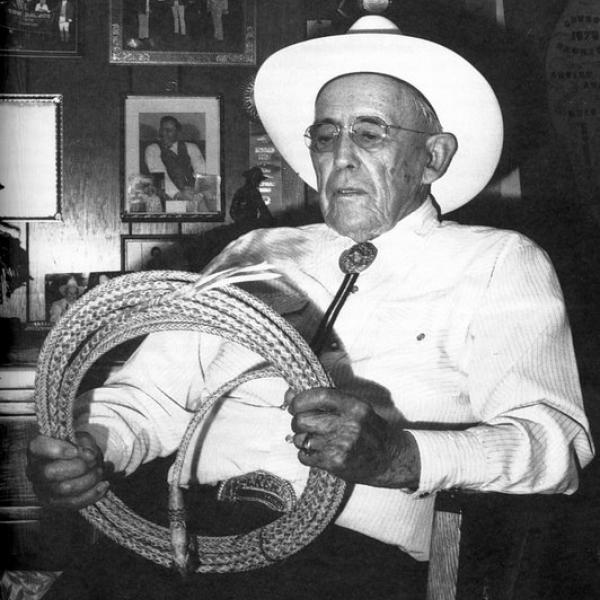 A man holding a hat rim.
