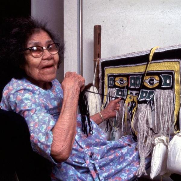 A woman at a loom.