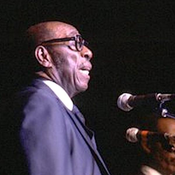 Man singing into a microphone.