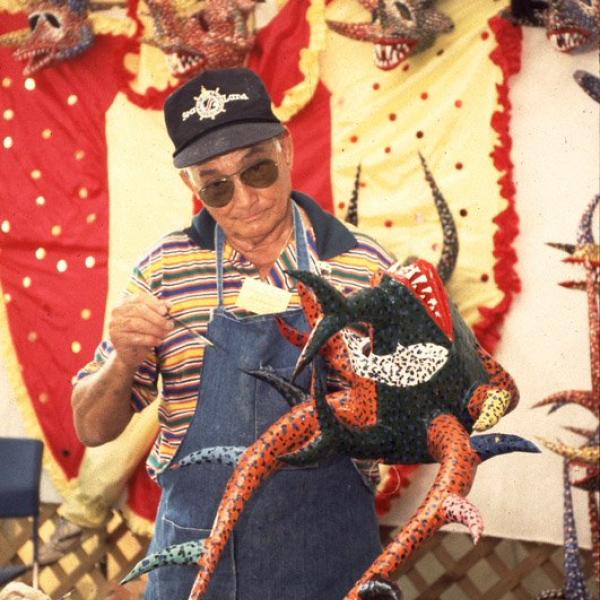 A man holding a mandmade mask.