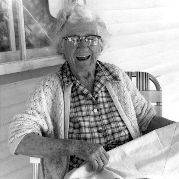 A woman showing an embroidery.