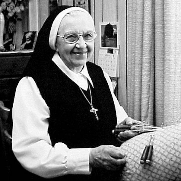 A woman posing with a handicartf lace.