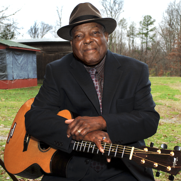 A man holding a guitar.
