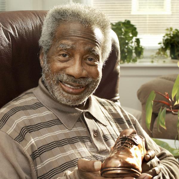 A man holding a shoe in his hand.