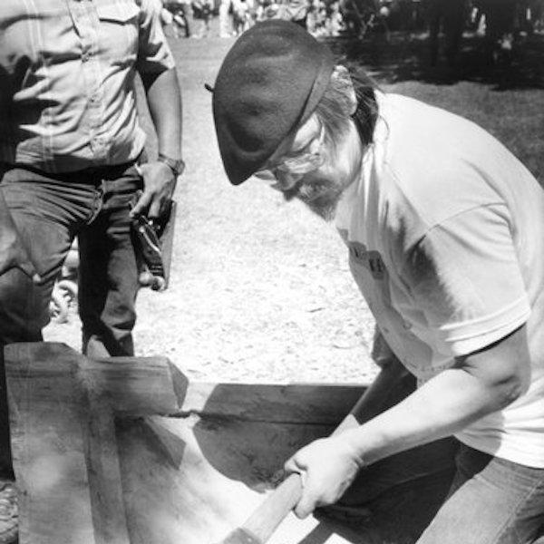 A man carving a canoe.
