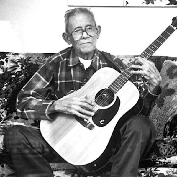 A man playing the guitar.