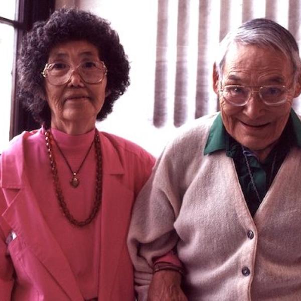 A man and a woman sittingh side by side.