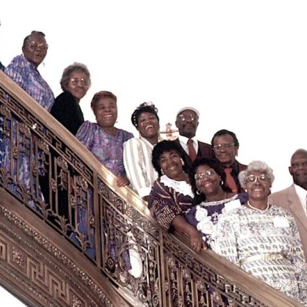 A gropu of people posing on a staircase.