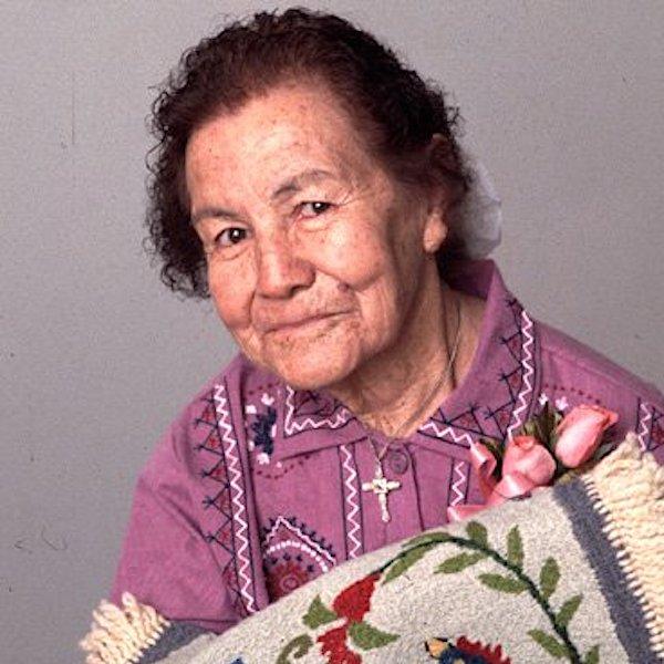A woman showing a weaving.