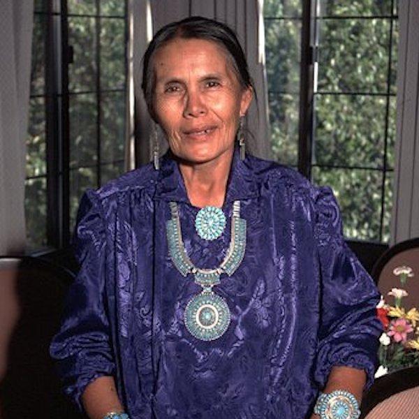A woman in native dress poses for the camera.
