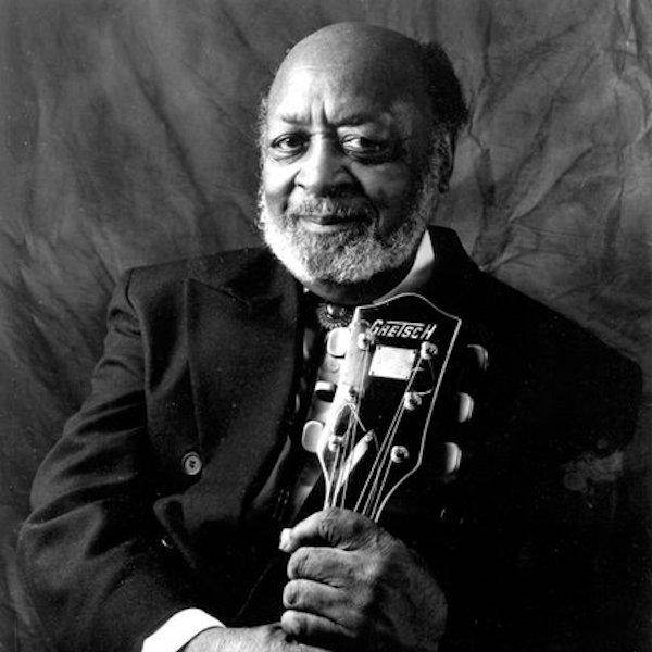 A man holding a guitar.
