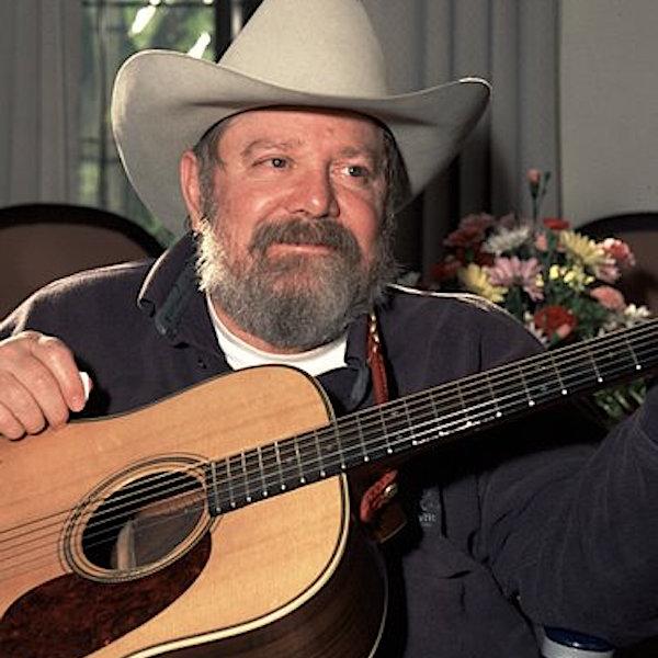 A man holding a guitar.