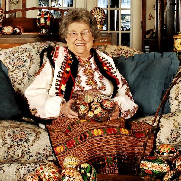 A woman sitting with her crafts.