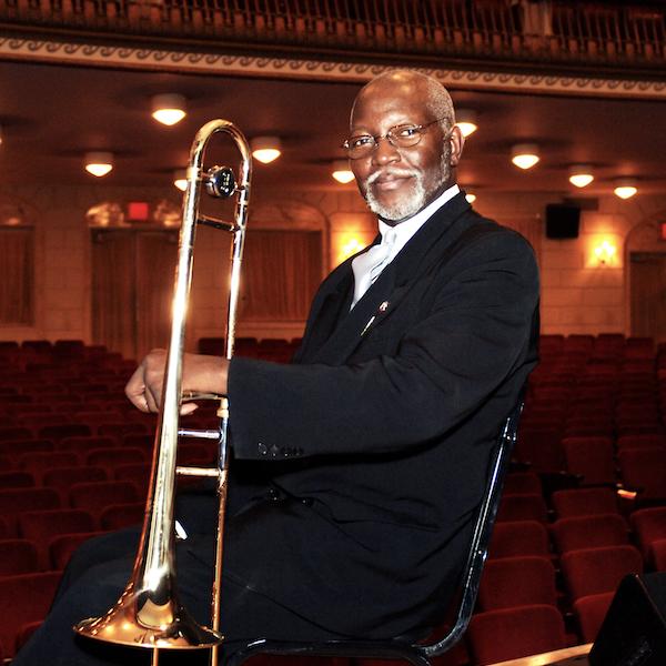 A man hiolding a trombone.