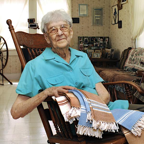 A woman on a reclining chair showing weavins.