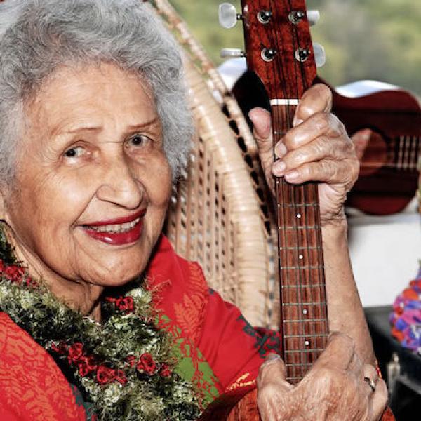 Woman holding a ukelele.
