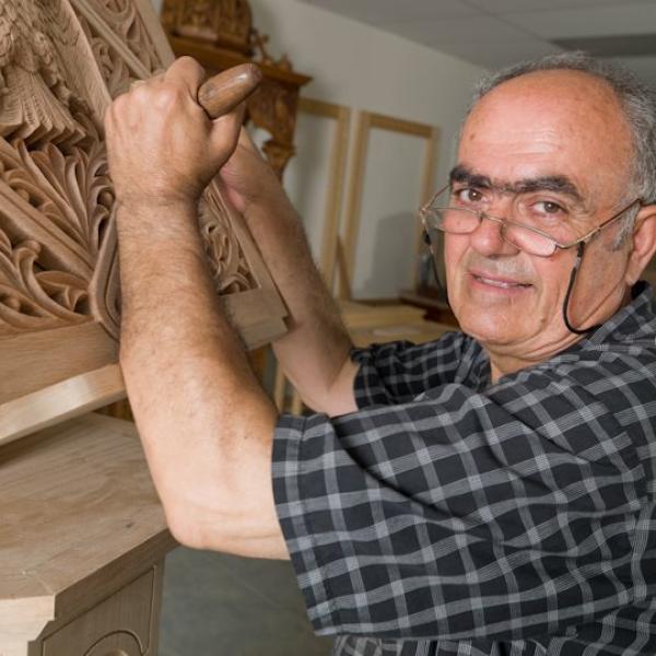 A man making a wood carving.