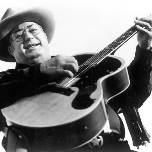 A man plying a guitar.
